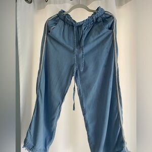 Soft light denim material pants with white embroidery on side seam